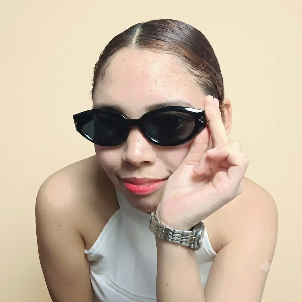 Jonalyn Ruz wearing black sunglasses and smiling at the camera
